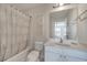 Clean bathroom with shower and tub combination with framed mirror and floral artwork at 2505 Dharma Cir, Kissimmee, FL 34746