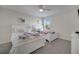 Bright bedroom featuring two twin beds with white frames, colorful bedding, and a ceiling fan at 2505 Dharma Cir, Kissimmee, FL 34746