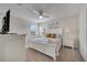 This pristine bedroom includes luxury bed, ceiling fan, dresser and warm natural light at 2505 Dharma Cir, Kissimmee, FL 34746