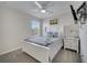 This bedroom includes luxury bed, ceiling fan, dresser and warm natural light at 2505 Dharma Cir, Kissimmee, FL 34746