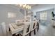 Well-lit dining area leading to a living room, featuring a stylish table, chairs, and modern decor at 2505 Dharma Cir, Kissimmee, FL 34746