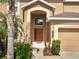 Charming home exterior showcasing a prominent front door, inviting curb appeal and well maintained landscaping at 2505 Dharma Cir, Kissimmee, FL 34746