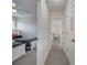 Hallway with bedrooms on either side and gray carpet at 2505 Dharma Cir, Kissimmee, FL 34746