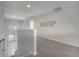 Upstairs hallway features carpeted floors, natural light, and neutral walls with access to all bedrooms at 2505 Dharma Cir, Kissimmee, FL 34746