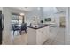Open-concept kitchen with a black granite island, pendant lighting, and views of the dining area at 2505 Dharma Cir, Kissimmee, FL 34746