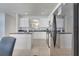 Bright kitchen with white cabinets, stainless steel appliances, and black countertops at 2505 Dharma Cir, Kissimmee, FL 34746