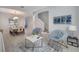 Cozy living room with stylish seating, a modern coffee table, and a view into the dining area at 2505 Dharma Cir, Kissimmee, FL 34746