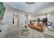 Open-concept living room with a couch, modern furniture, and a view of the kitchen at 2505 Dharma Cir, Kissimmee, FL 34746