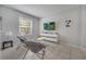 Modern living room with a wall-mounted TV, comfortable seating, and a bright window at 2505 Dharma Cir, Kissimmee, FL 34746