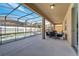 Spacious screened-in patio features a covered seating area and overlooks the pool at 2505 Dharma Cir, Kissimmee, FL 34746