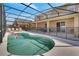Inviting in-ground pool with safety fence and screened-in enclosure with a patio at 2505 Dharma Cir, Kissimmee, FL 34746