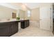 Bright bathroom with double sinks, soaking tub, and neutral finishes at 2769 Bookmark Dr, Kissimmee, FL 34746