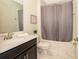 Cozy bathroom with a dark vanity, combined tub and shower and decorative accents at 2769 Bookmark Dr, Kissimmee, FL 34746