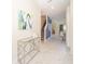 Hallway with marble tile flooring and a contemporary table and abstract artwork at 2769 Bookmark Dr, Kissimmee, FL 34746