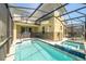 Private pool area with a screen enclosure, including a pool and hot tub at 2769 Bookmark Dr, Kissimmee, FL 34746