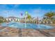 Community splash pad with colorful features, seating, and lush palm trees for a fun, Gathering-friendly environment at 2769 Bookmark Dr, Kissimmee, FL 34746