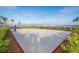 Sunny sand volleyball court with well manicured landscape near a lake at 2769 Bookmark Dr, Kissimmee, FL 34746