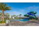 Community water slide at the pool area with seating and views of the mini-golf and nearby palm trees at 2769 Bookmark Dr, Kissimmee, FL 34746