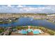 Aerial view of community pool and lake with surrounding homes at 2927 Windmill Dr, Kissimmee, FL 34741