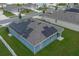 Aerial view of home featuring solar panels and lush green lawn in residential area at 3617 Scarlet Oak Dr, St Cloud, FL 34772