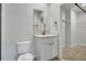 Bathroom showcasing a white vanity, toilet, and a neutral color scheme at 3617 Scarlet Oak Dr, St Cloud, FL 34772