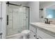 Bright bathroom featuring a glass shower, toilet, and vanity with modern fixtures at 3617 Scarlet Oak Dr, St Cloud, FL 34772