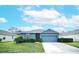 Charming single-story home featuring a well-maintained lawn and attached garage at 3617 Scarlet Oak Dr, St Cloud, FL 34772