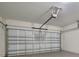 Spacious garage featuring a white door and an automatic door opener at 3617 Scarlet Oak Dr, St Cloud, FL 34772