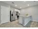 Kitchen featuring stainless steel appliances, ceramic tile flooring, and breakfast bar at 3617 Scarlet Oak Dr, St Cloud, FL 34772