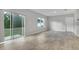 Bright living room featuring ceramic tile flooring, sliding glass doors and backyard view at 3617 Scarlet Oak Dr, St Cloud, FL 34772