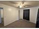 Bedroom with neutral carpet, ceiling fan, and closet at 3715 1/2 Avenue J Nw, Winter Haven, FL 33881