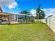 Spacious backyard with a screened pool and grassy area at 4610 Salamander St, St Cloud, FL 34772