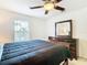 Bedroom with dark wood dresser and ceiling fan at 4610 Salamander St, St Cloud, FL 34772