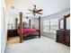 Main bedroom with a large four-poster bed and plenty of natural light at 4610 Salamander St, St Cloud, FL 34772