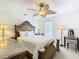 Main bedroom with ornate bed frame and ceiling fan at 4610 Salamander St, St Cloud, FL 34772