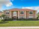 Front view of a two-story house with a brown facade, red roof, and well-maintained lawn at 4610 Salamander St, St Cloud, FL 34772