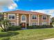Two-story house with a brown facade, red roof, and manicured lawn at 4610 Salamander St, St Cloud, FL 34772