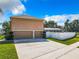 Two-car garage with driveway and view of the backyard at 4610 Salamander St, St Cloud, FL 34772