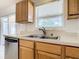 Kitchen features a double sink, wood cabinets and stainless steel dishwasher at 4610 Salamander St, St Cloud, FL 34772