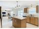 Kitchen with island, wood cabinets, and stainless steel appliances at 4610 Salamander St, St Cloud, FL 34772