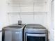 Bright laundry room, featuring washer, dryer, and ample shelving at 4610 Salamander St, St Cloud, FL 34772