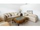 Sitting area with neutral colored sofa and chaise lounge at 4610 Salamander St, St Cloud, FL 34772