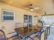 Outdoor patio with table, chairs, ceiling fans, and view of the pool at 4610 Salamander St, St Cloud, FL 34772
