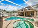 Resort-style pool and spa with covered patio and lounge chairs at 4610 Salamander St, St Cloud, FL 34772