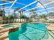 Inviting screened pool and spa with lounge chairs at 4610 Salamander St, St Cloud, FL 34772