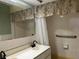 Bathroom with double sinks, a large mirror, tiled walls, and neutral countertop at 112 10Th St, St Cloud, FL 34769