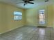 Well-lit room with access to the lanai with ceiling fan and neutral ceramic tile flooring at 112 10Th St, St Cloud, FL 34769