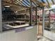 Greenhouse has custom shelving, a metal door, and a custom sign about who aims at nothing at 112 10Th St, St Cloud, FL 34769