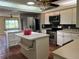 Bright eat-in kitchen features stainless steel appliances, kitchen island, and tile flooring at 112 10Th St, St Cloud, FL 34769