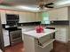 Bright kitchen with an island offering ample counter space and room for seating at 112 10Th St, St Cloud, FL 34769